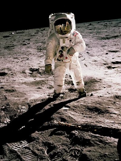 Edwin Aldrin walking lunar surface. poster