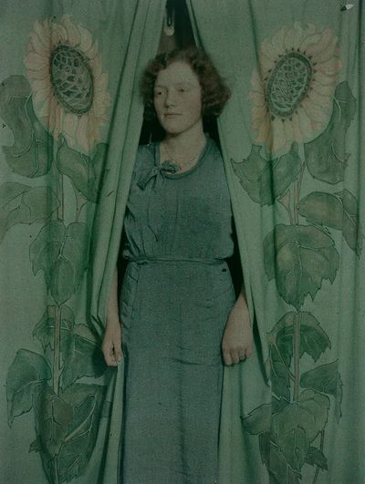 Woman sunflower print curtains (1900-1930). poster